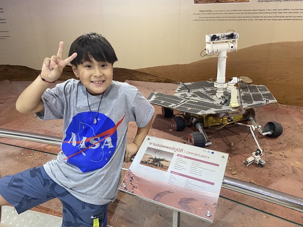 Son by NASA Mars Rover Opportunity exhibit at a science museum