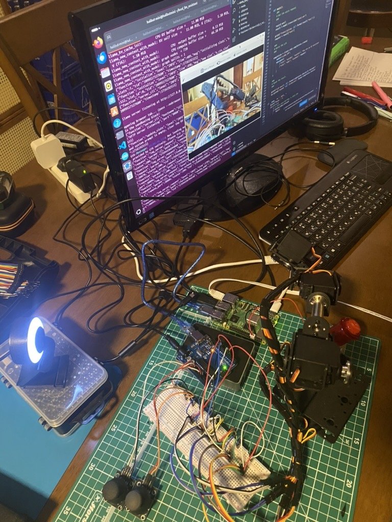 DIY robotics workstation with Raspberry Pi, breadboard circuits, and monitor running local llama.cpp AI server with Python code